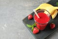 Glass with tasty strawberry smoothie and fresh fruits on wooden board Royalty Free Stock Photo