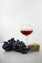 Glass of tasty wine, grapes and cheese on white background Royalty Free Stock Photo