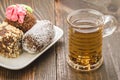 Glass of tea and abundance of cakes/glass of tea and abundance of cakes on a wooden background. selective focus