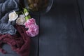 A glass of tea on a black wooden background and flowers. Copy cpace