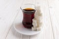 A glass of tea and a pile of sugar cubes. Royalty Free Stock Photo