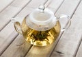 A glass tea pot with Flower Chinese tea on wooden background Royalty Free Stock Photo