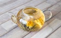 A glass tea pot with Flower Chinese tea on wooden background Royalty Free Stock Photo