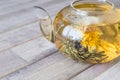 A glass tea pot with Flower Chinese tea on wooden background Royalty Free Stock Photo