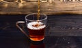 Glass with tea pouring with liquid with splashes and drops of water. Brewing tea concept. Cup pouring with water or tea Royalty Free Stock Photo