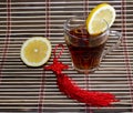 Glass of tea on a rug with a lemon Royalty Free Stock Photo