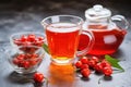 glass teapot with brewed rose hip tea on a stone countertop Royalty Free Stock Photo