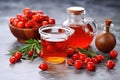 glass teapot with brewed rose hip tea on a stone countertop Royalty Free Stock Photo