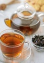 Glass teapot and cup of herbal tea Royalty Free Stock Photo