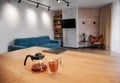 Glass teapot and cups of tea on wooden table.