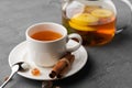 Glass teapot with fruit tea on gray background Royalty Free Stock Photo