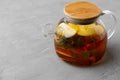 Glass teapot with fruit tea on gray background Royalty Free Stock Photo