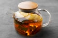 Glass teapot with fruit tea on gray background Royalty Free Stock Photo