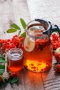 Glass teapot with hot beverage - berry apple citrus honey tea. Vitamins for autumn, winter. Immunity treatment for cold fall days Royalty Free Stock Photo