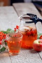 Glass teapot with hot beverage - berry apple citrus honey tea. Vitamins for autumn, winter. Immunity treatment for cold fall days Royalty Free Stock Photo