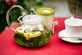 Glass teapot with mint green tea and cup Royalty Free Stock Photo