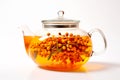 A glass teapot with sea-buckthorn berries, oolong tea in glass kettle isolated on white background. Chinese tea ceremony Royalty Free Stock Photo