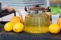 Glass teapot with sea-buckthorn berry tea. Sea-buckthorn tea at the food fair