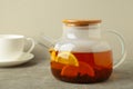 Glass teapot with tea and cup on grey background Royalty Free Stock Photo