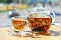 A  glass teapot with tea and a glass cup with tea stand on the table ON A LIGHT BACKGROUND Royalty Free Stock Photo