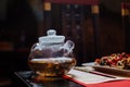 A glass teapot in which Chinese green tea is brewed Royalty Free Stock Photo