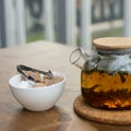 Glass teapot and white porcelain sugar bowl on a wooden table. Shallow depth of field. Background blurred Royalty Free Stock Photo