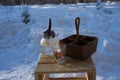 a glass teapot and a wicker basket stand on a wooden chair outside Royalty Free Stock Photo