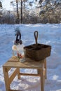 a glass teapot and a wicker basket stand on a wooden chair outside Royalty Free Stock Photo