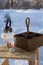 a glass teapot and a wicker basket stand on a wooden chair outside Royalty Free Stock Photo