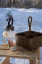 a glass teapot and a wicker basket stand on a wooden chair outside Royalty Free Stock Photo