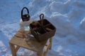 a glass teapot and a wicker basket stand on a wooden chair outside Royalty Free Stock Photo