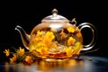 A glass teapot with yellow flowers, oolong tea in glass kettle on wooden table. Chinese traditional tea ceremony