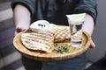 The glass of tequila with lime and portion of quesadilla on round board