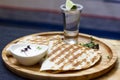 The glass of tequila with lime and portion of quesadilla on round board