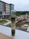 Soil Test Tube on Lab Table With Background View of Construction Site in Clear Weather During the Day Royalty Free Stock Photo