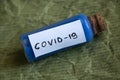 Glass test tube with a label and the inscription covid-19 on it on an isolated background