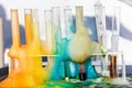 Glass test tubes with liquid in it and colorful foam in science research lab. Failed experiment concept Royalty Free Stock Photo