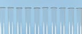 Glass test tubes with a vertical reflection on the walls, lined up in an even row, against a blue background