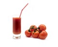 Glass with tomato juice with drink straw and ripe tomatoes studio shot isolated on white Royalty Free Stock Photo