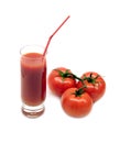 Glass with tomato juice with drink straw and ripe tomatoes studio shot on white Royalty Free Stock Photo