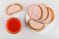 Glass of tomato juice, pieces of sausage, sandwiches with sausage Royalty Free Stock Photo