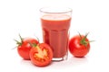 Glass with tomato juice and ripe tomatoes. Royalty Free Stock Photo