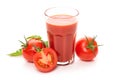 Glass with tomato juice and ripe tomatoes. Royalty Free Stock Photo