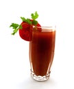 Glass of tomato juice with a segment of a tomato and parsley