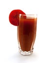 Glass of tomato juice with a tomato segment