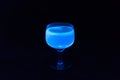 Glass of tonic with lemon glowing in UV light.