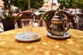 A glass and a traditional tea pot on a table Royalty Free Stock Photo