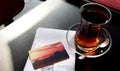 A glass of traditional Turkish tea, Istanbul transport card and HES code required to visit Turkey.