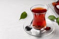 Glass of traditional Turkish tea and sugar cubes on white wooden table, closeup. Space for text Royalty Free Stock Photo