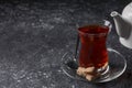Glass of traditional Turkish tea and sugar on grey textured table, closeup. Space for text Royalty Free Stock Photo
